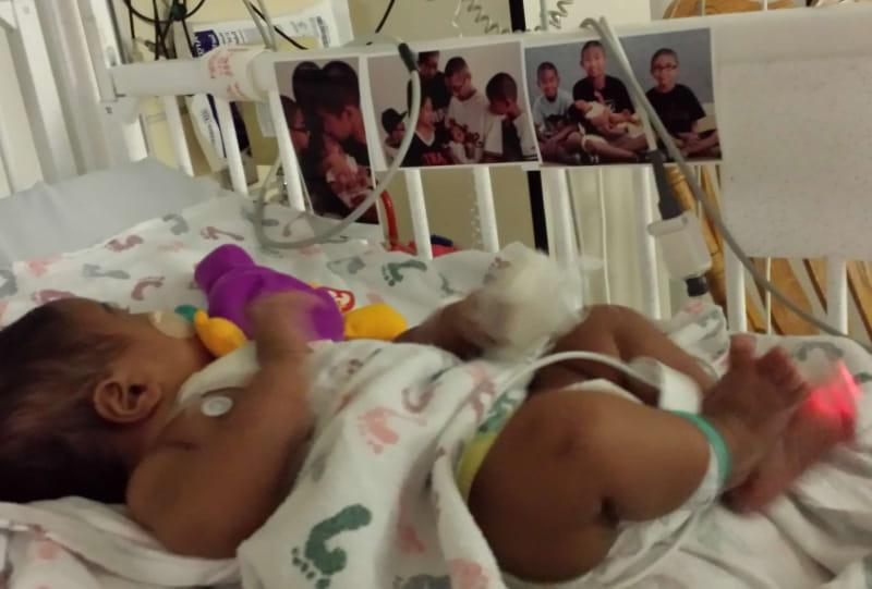 Luke Domingo was in the hospital for over a week to recover from his first heart surgery as an infant. His parents taped family photos in his crib to comfort him. (Photo courtesy of Mia Domingo)